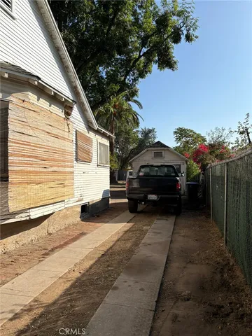 a view of a car parked in back yard of a house