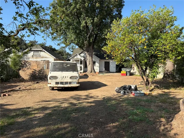 a view of white house with a yard