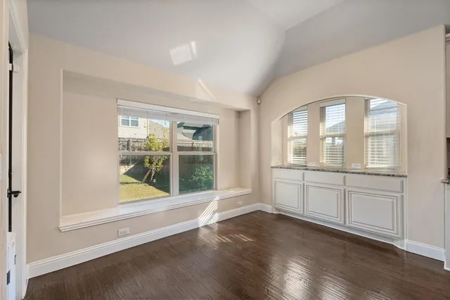 a large kitchen with cabinets table and chairs