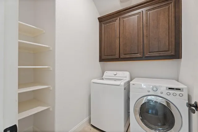 a kitchen with stainless steel appliances granite countertop a refrigerator a oven and a sink with wooden floor