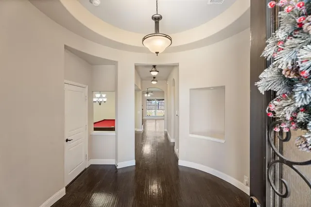 a view of a hallway to a livingroom with furniture