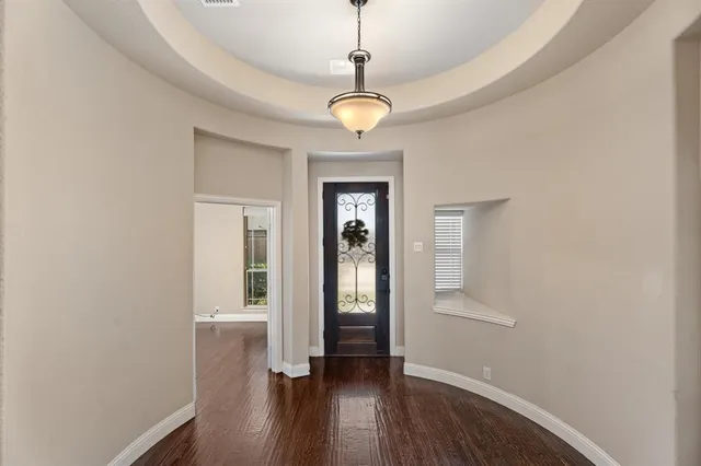 a view of an entryway with wooden floor and a window