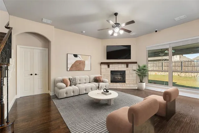 a living room with furniture a fireplace and a flat screen tv