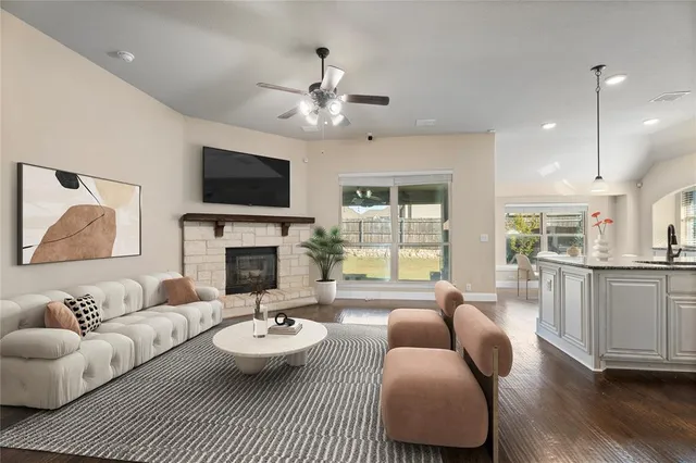 a living room with furniture a fireplace and a flat screen tv