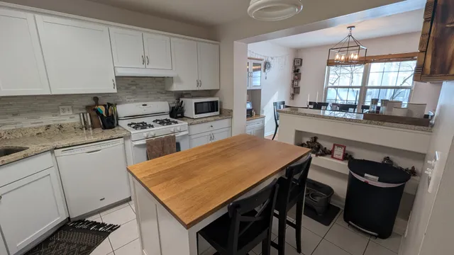 a kitchen with a stove a sink and a refrigerator
