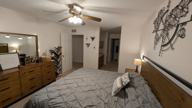 a bedroom with a large bed and a chandelier