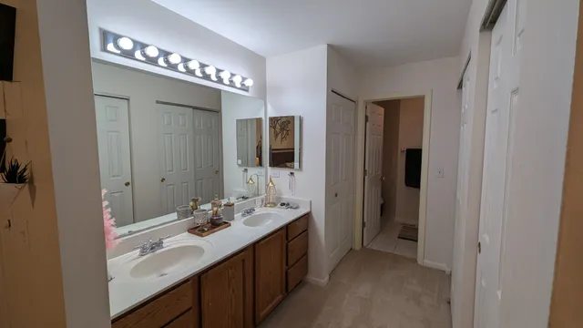 a bathroom with a double vanity sink and a mirror