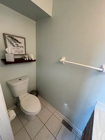 a white toilet sitting next to a bathroom sink