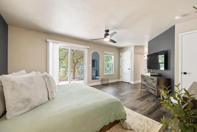 a spacious bedroom with a bed and large windows