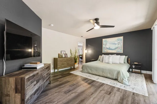 a bedroom with a bed and a flat screen tv