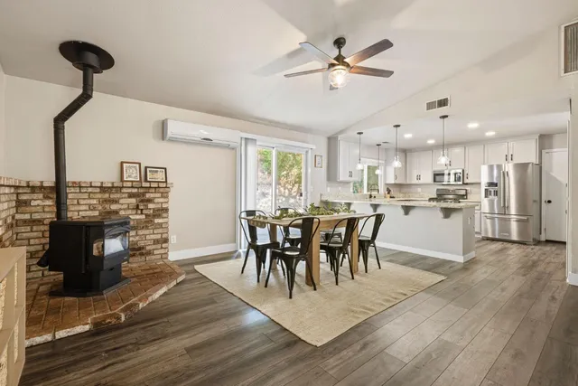 a view of a dining room with furniture and a kitchen view