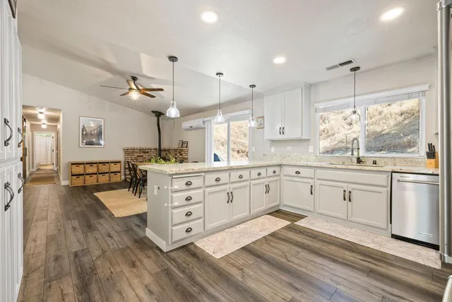 a large white kitchen with cabinets