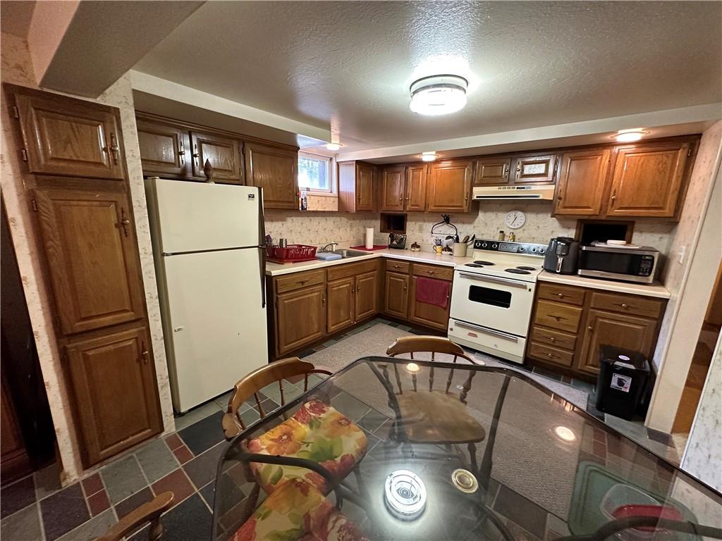 175 Fair Road Indiana, PA 15701 - Photo 15 of 21 a kitchen with stainless steel appliances granite countertop a refrigerator a stove and a sink