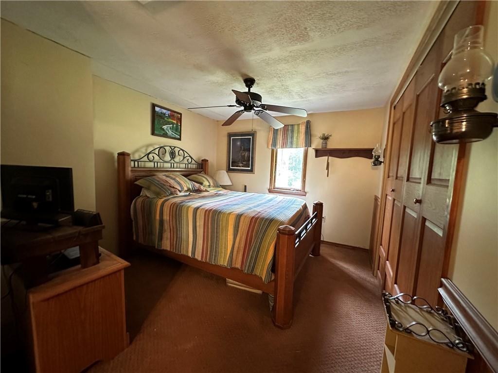 175 Fair Road Indiana, PA 15701 - Photo 10 of 21 a bedroom with a bed and a chandelier