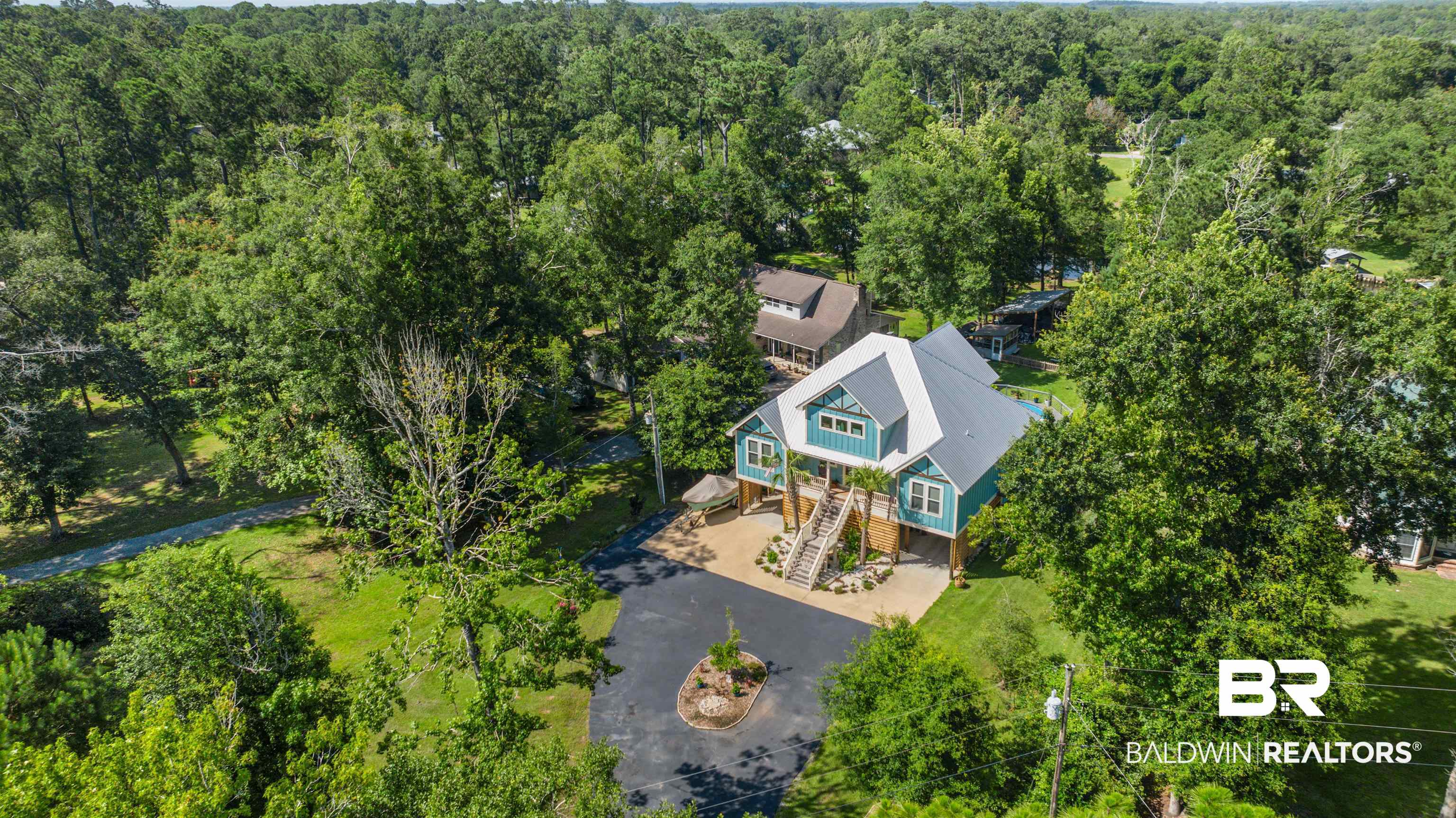 7266 Franklin Road Foley, AL 36535 - Photo 62 of 64 Elevated coastal-style residence featuring a prominent metal roof and light blue siding