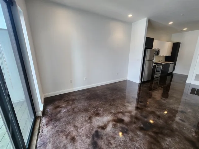 an empty room with windows and closet