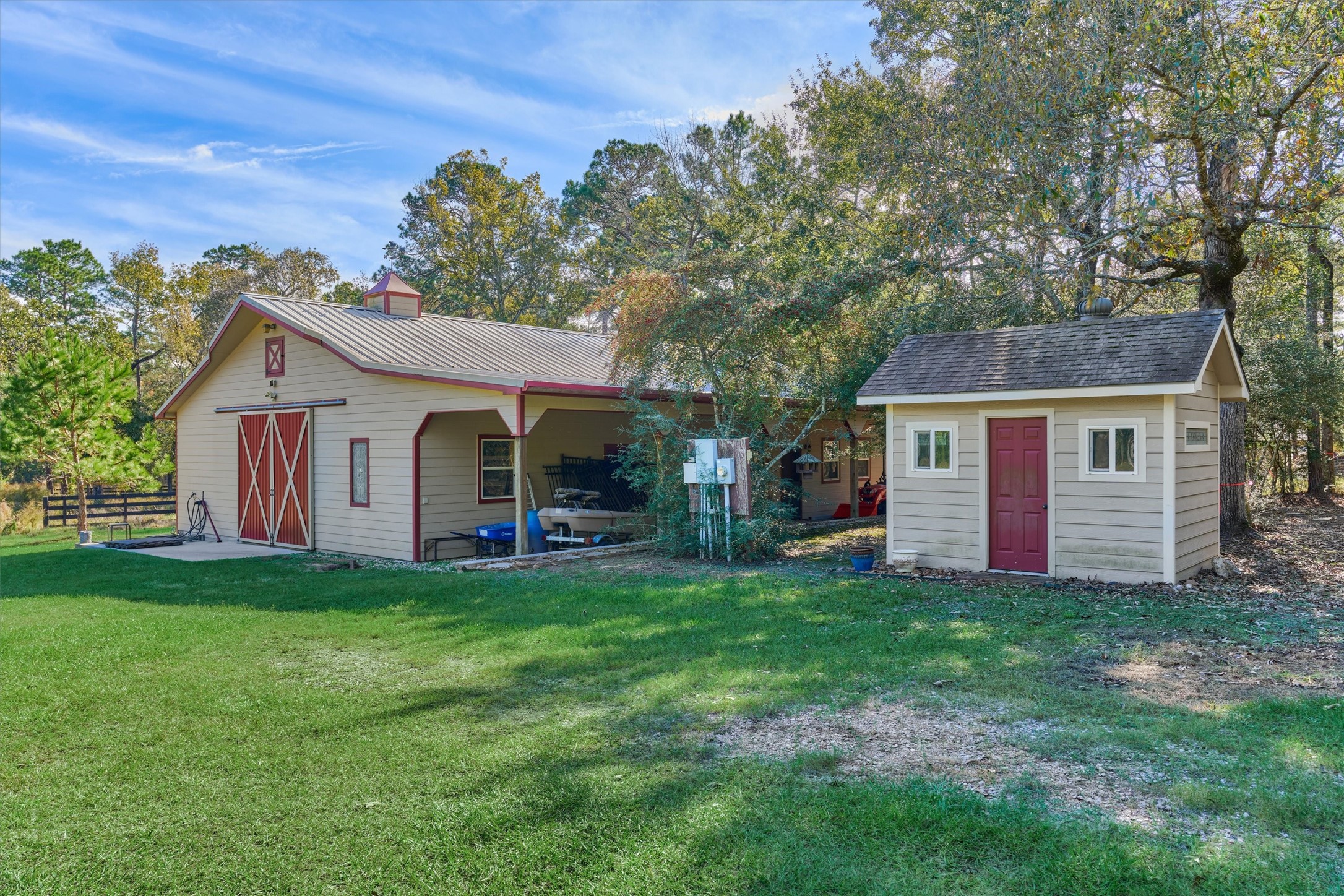 0 Koenig Lane Conroe, TX 77384 - Photo 4 of 19 Premium 1800sf barn + well house offers flex space for storage and more! Covered patio overlooks serene lot and wooded surroundings!