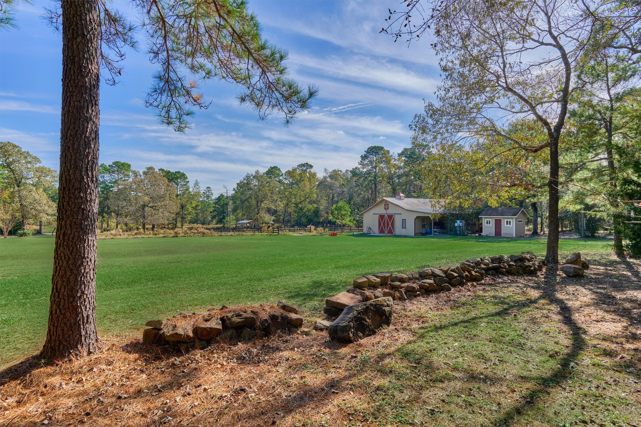 0 Koenig Lane Conroe, TX 77384 - Photo 8 of 19 Boundary line sits on this side of the rocks - seller to split cost of fence between these properties.