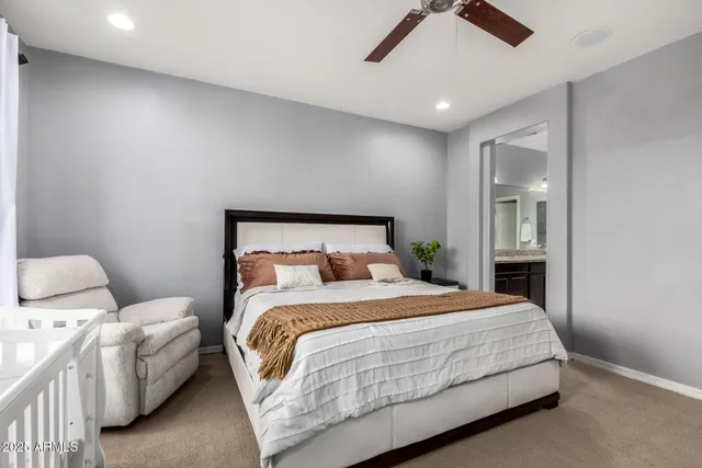 a bedroom with a bed and a ceiling fan