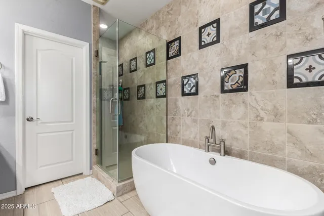 a white bath tub sitting next to a white wall