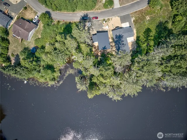 an aerial view of a house with a yard and garden