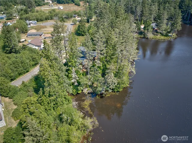 an aerial view of residential house with outdoor space and trees around