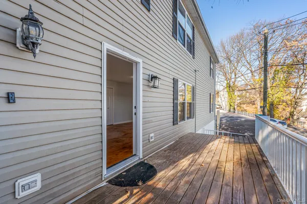 a view of a patio with wooden floor and a yard