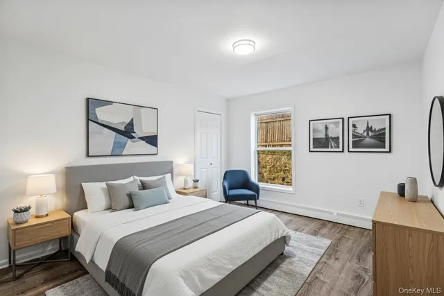 a bedroom with a bed and a painting on the wall