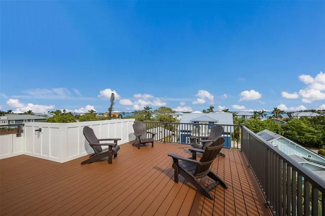 a balcony with wooden floor in front of a house