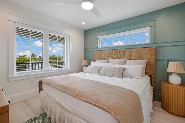 a bedroom with a bed and a painting on the wall