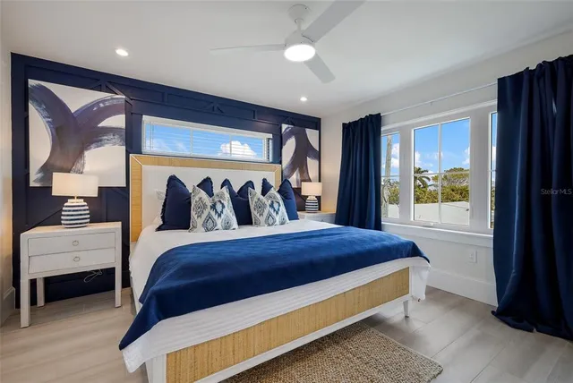 a bedroom with a bed and a painting on the wall