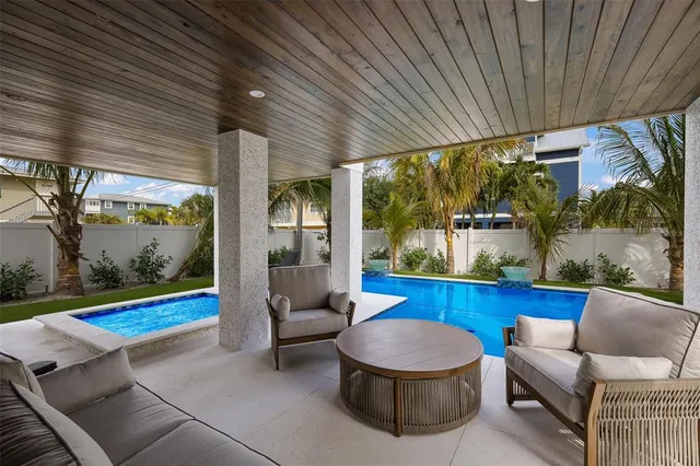 a front view of a house with swimming pool garden and patio