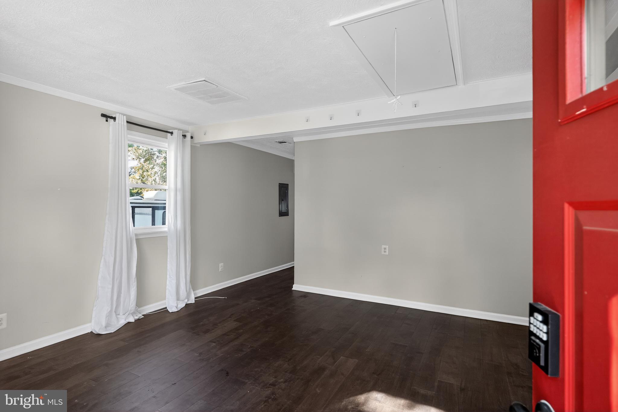 3670 5th Avenue Edgewater, MD 21037 - Photo 3 of 60 a view of an empty room with wooden floor and a window