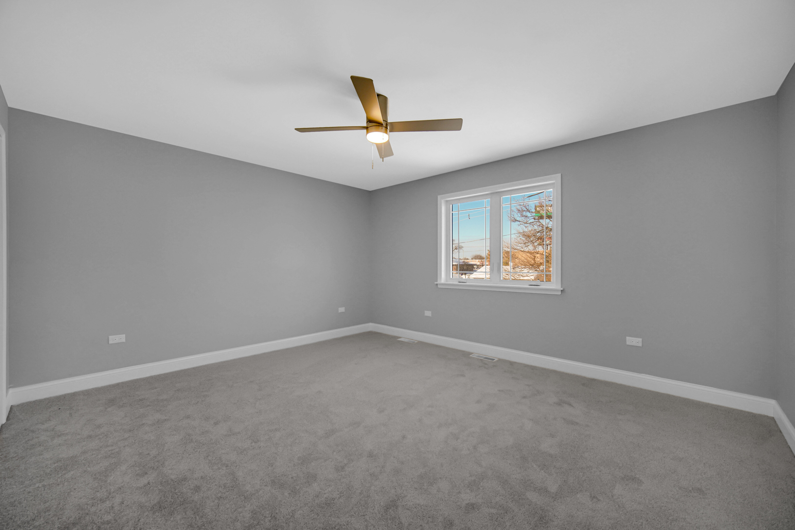 6532 West 112th Street Worth, IL 60482 - Photo 18 of 27 an empty room with a window and a ceiling fan