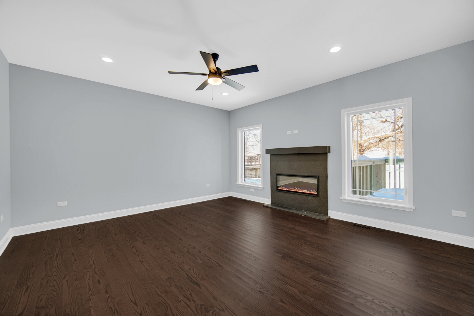 6532 West 112th Street Worth, IL 60482 - Photo 9 of 27 a view of wooden floor fire place and windows in an empty room