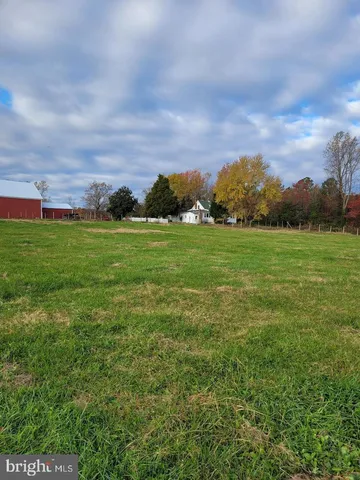 a view of a big yard with a large mountain
