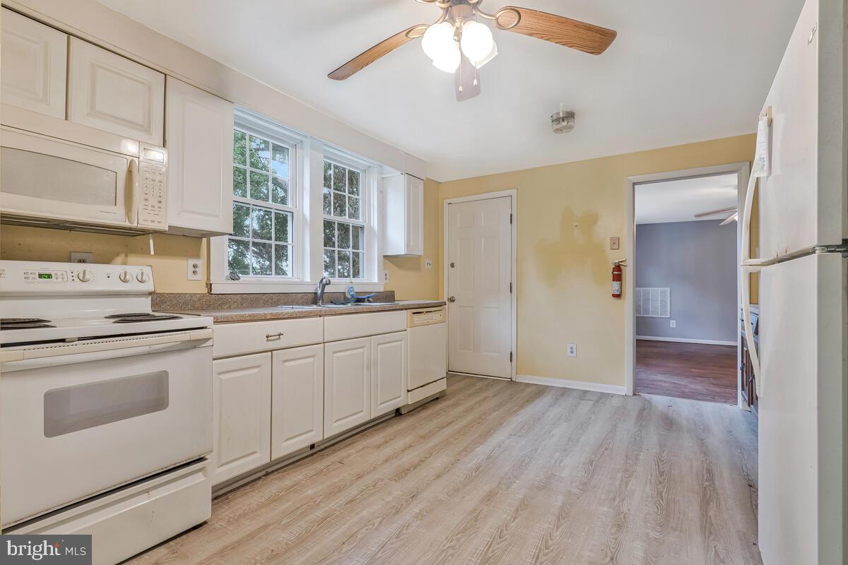 38888 Reeves Road Mechanicsville, MD 20659 - Photo 25 of 50 a kitchen with a sink cabinets stainless steel appliances and a window