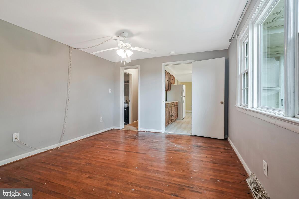 38888 Reeves Road Mechanicsville, MD 20659 - Photo 30 of 50 a view of an empty room with wooden floor and a window