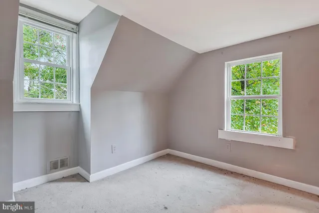a view of an empty room and fire place