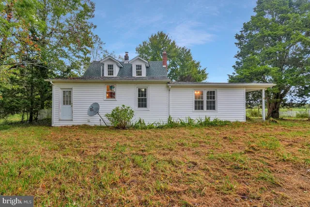 a house that has a tree in front of it