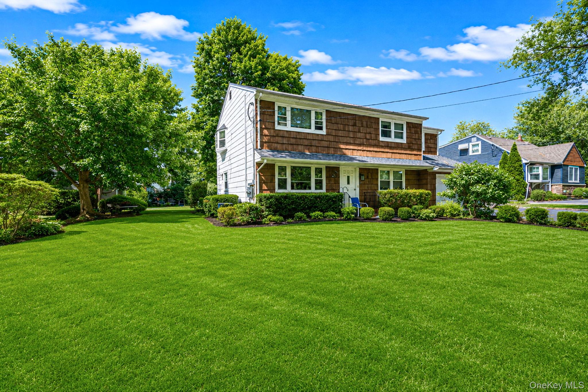 31 Crooked Hill Road Huntington, NY 11743 - Photo 3 of 32 Two-story residence featuring a shingled upper facade and white siding on the lower level