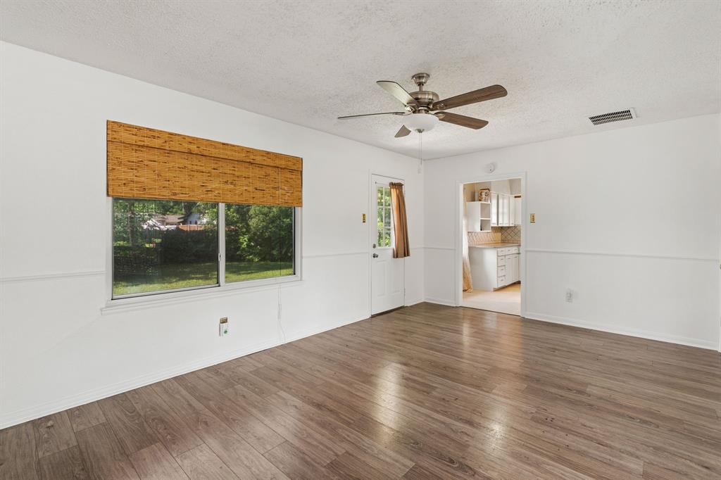 1822 Finley Road Irving, TX 75062 - Photo 12 of 38 a view of an empty room with a window and wooden floor