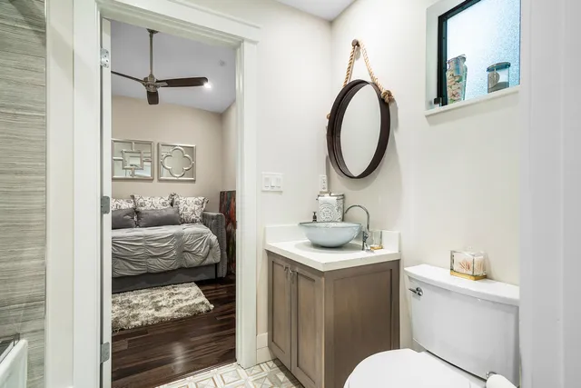 a bedroom with a bed and a desk