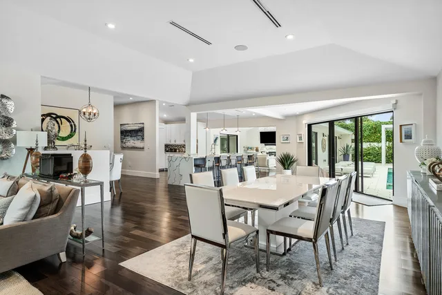 a dining area with a table chairs and a refrigerator