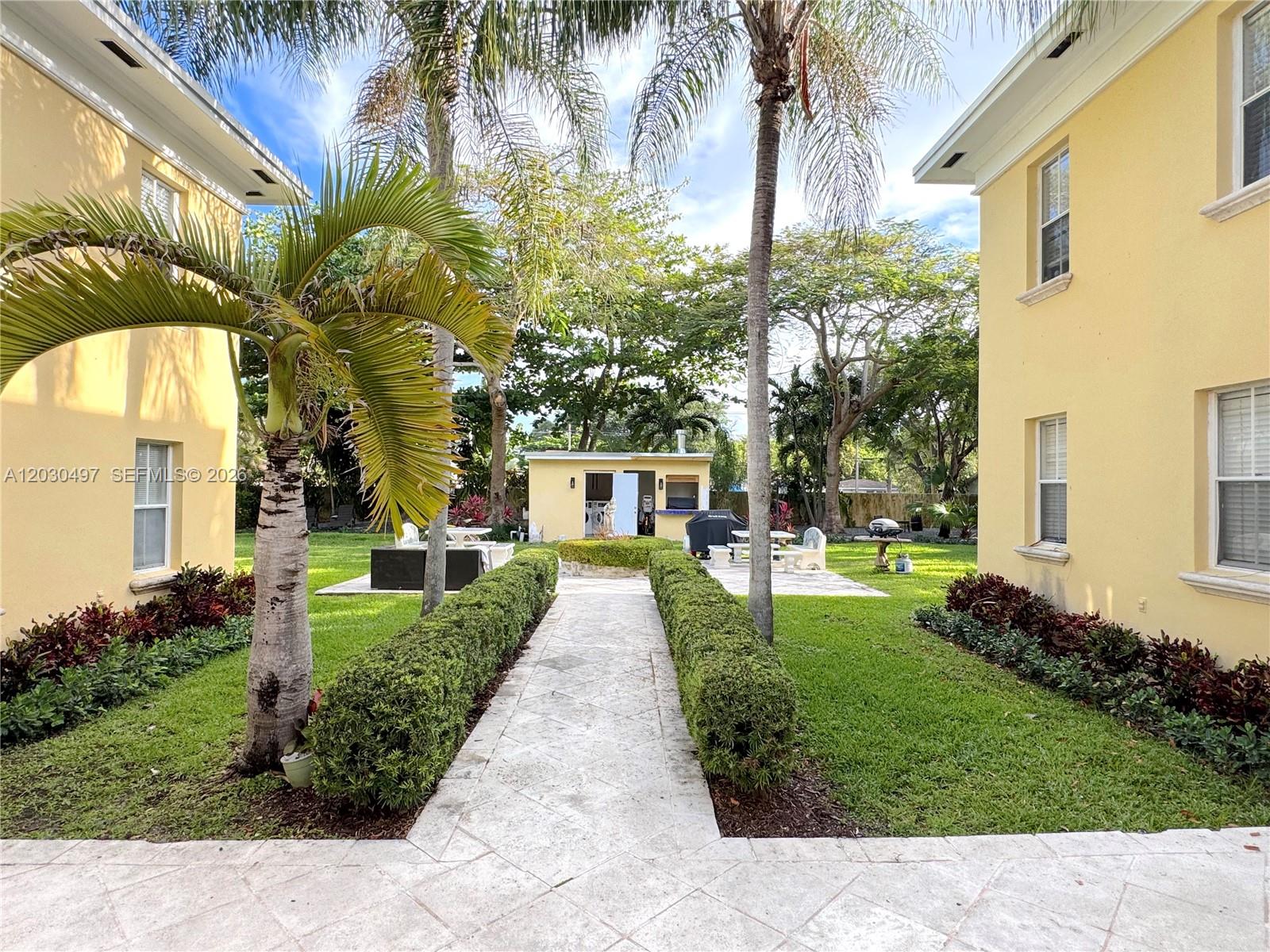 3375 Franklin Avenue, Unit D Miami, FL 33133 - Photo 24 of 29 a front view of a house with a garden and trees