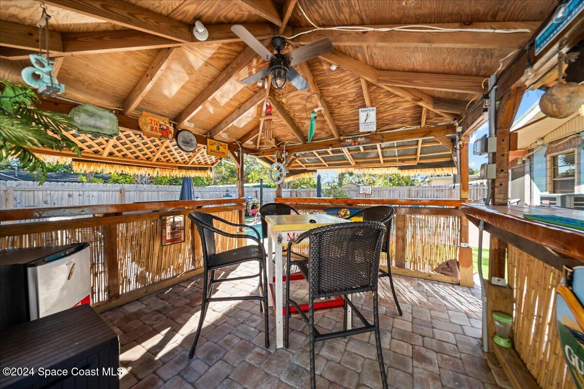 1509 Hedrick Drive Melbourne, FL 32901 - Photo 16 of 20 a view of a patio with table and chairs with wooden floor
