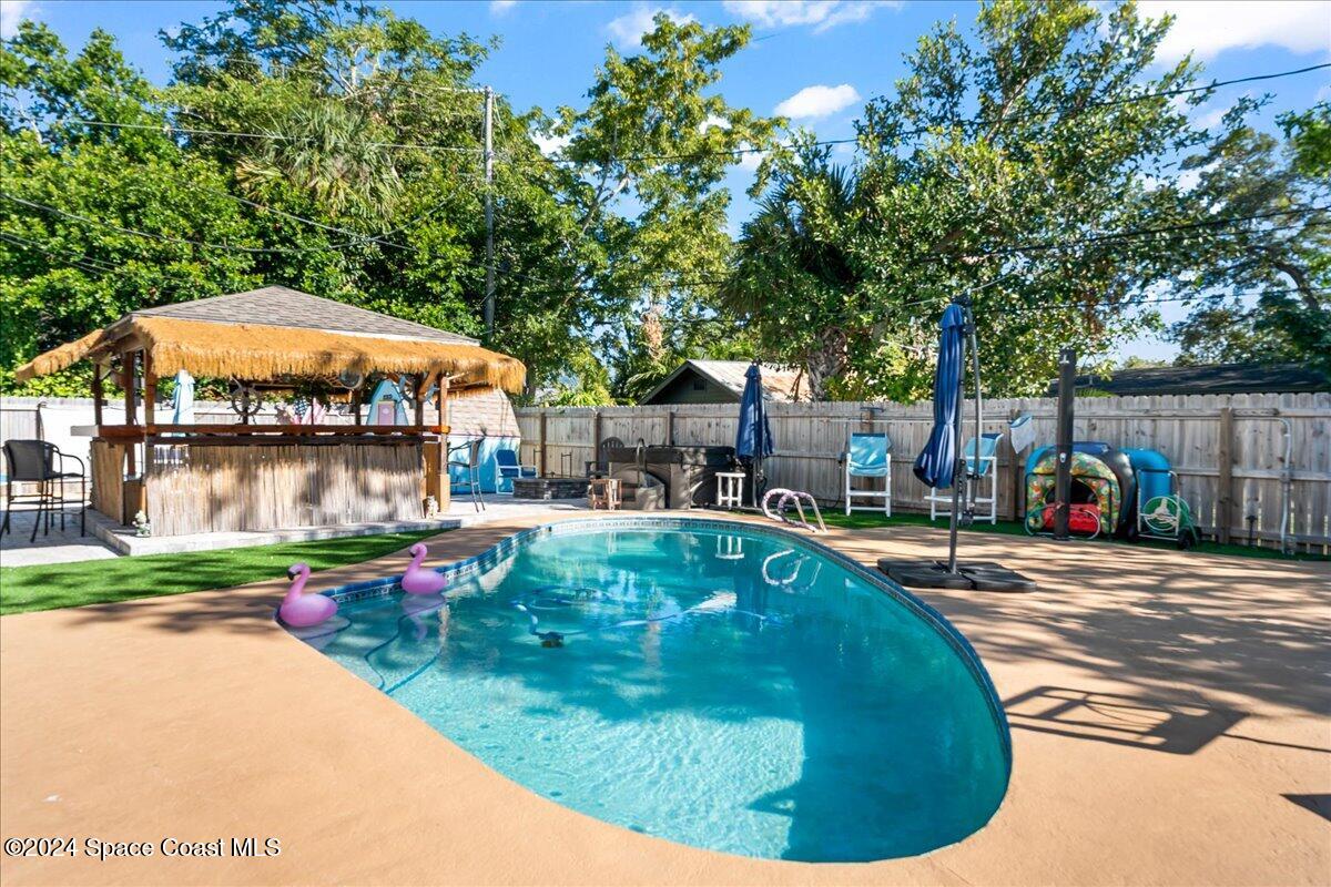 1509 Hedrick Drive Melbourne, FL 32901 - Photo 2 of 20 a view of a swimming pool with sitting area