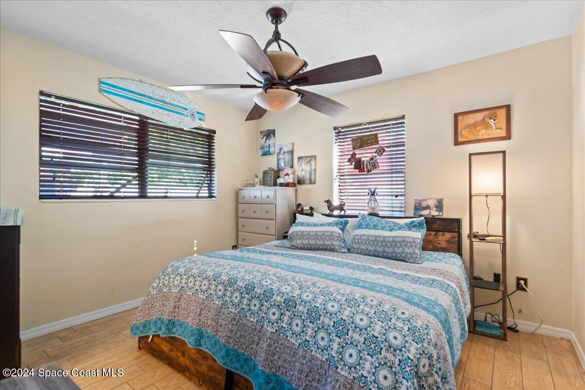 1509 Hedrick Drive Melbourne, FL 32901 - Photo 10 of 20 a bedroom with a bed a dresser and a window