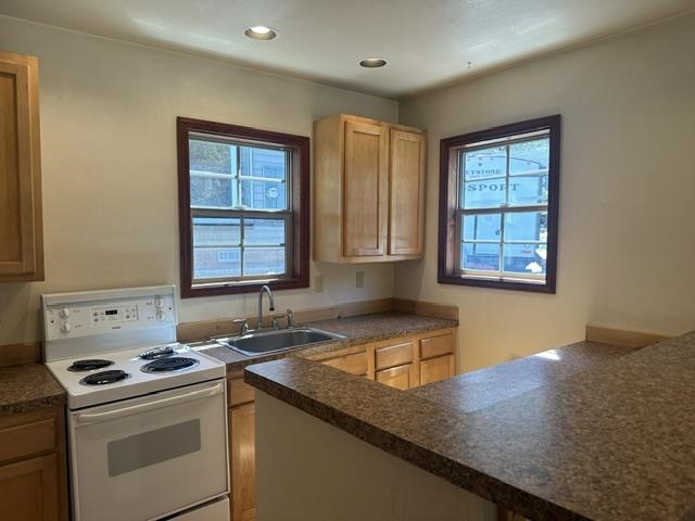 673 Minaret Road June Lake, CA 93529 - Photo 12 of 22 Kitchen featuring wood-finish cabinetry, speckled countertops, a stainless steel sink, and a white electric range
