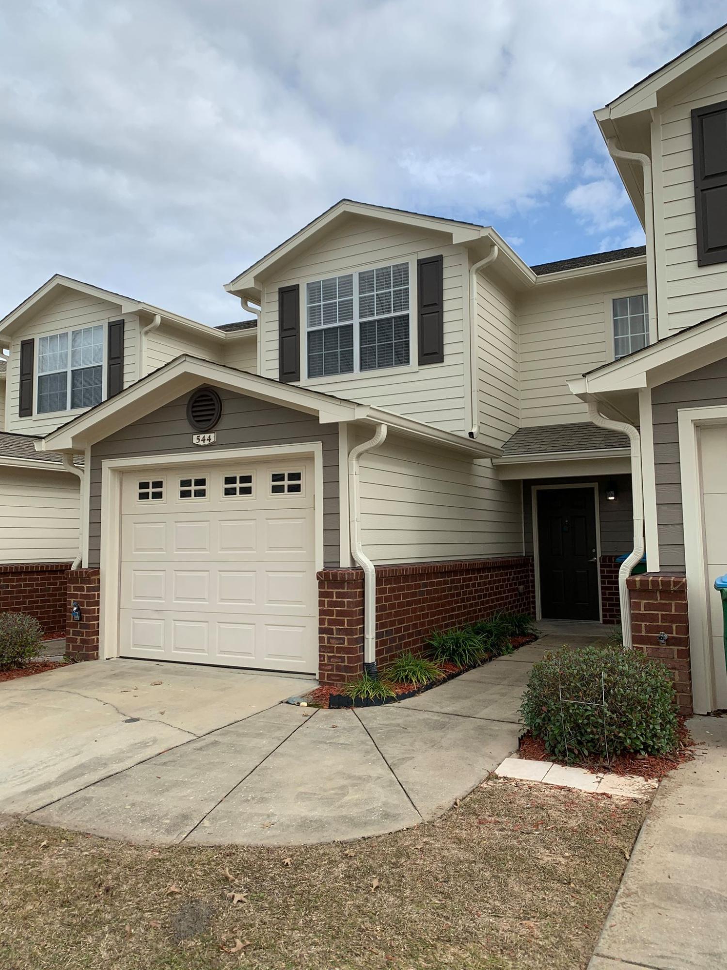 544 Wingspan Way, Unit 7C Crestview, FL 32536 - Photo 1 of 1 a front view of a house with a yard and garage